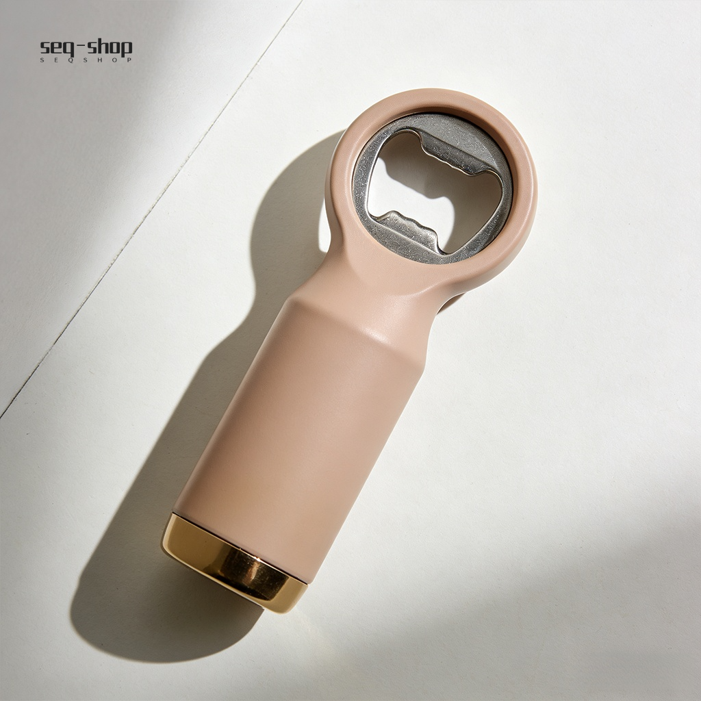 Close up of magnetic beer bottle opener catching caps