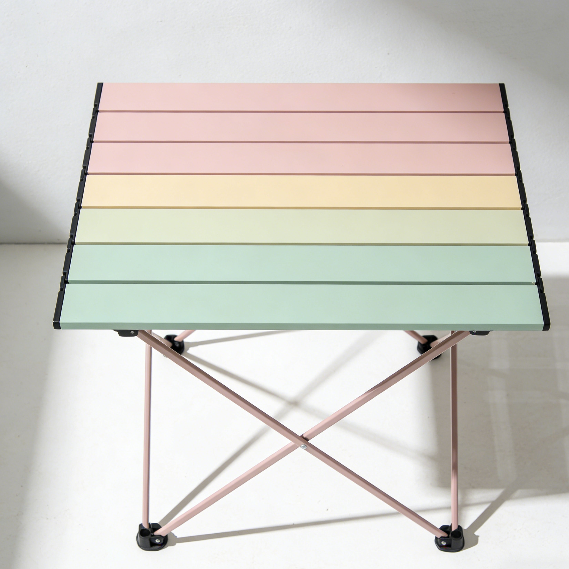 Portable outdoor folding table displayed in a campsite